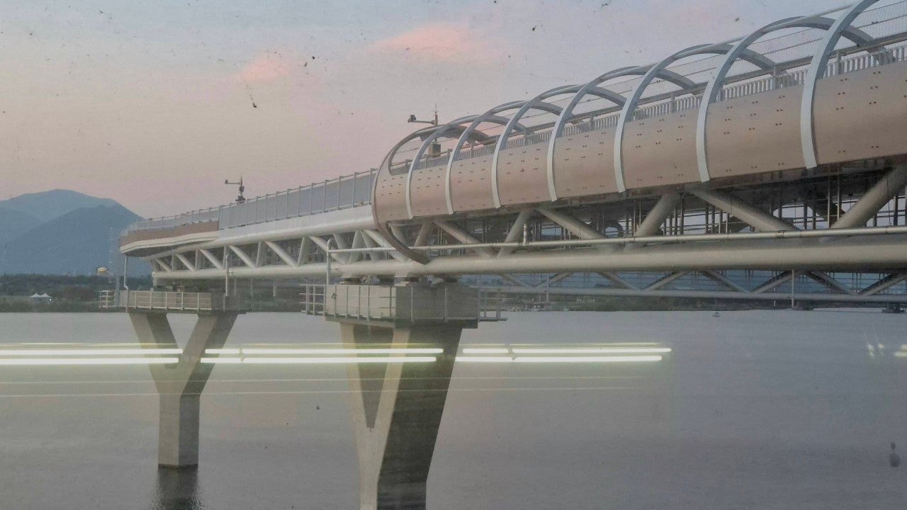 Elevated riverwalk bridge structure over the Nakdong River near Gupo Station, Busan, at dusk