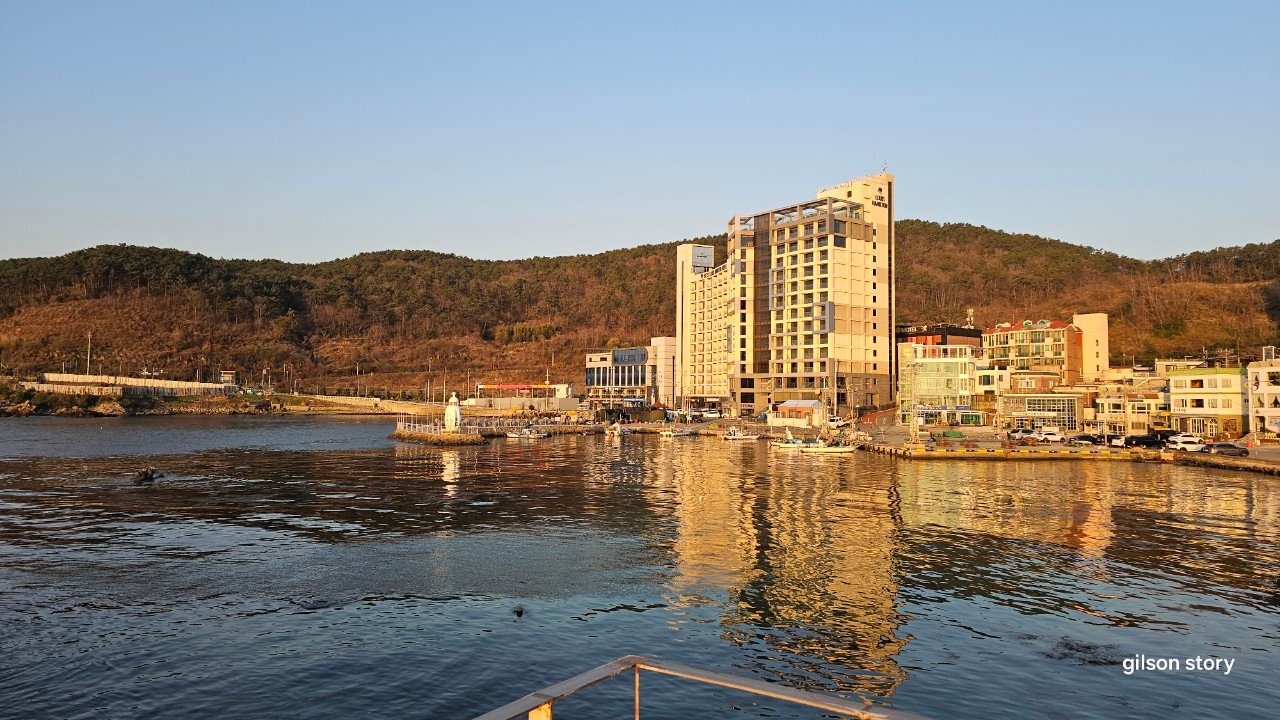 Seoam fishing village harbor with hotel and hills in the background, Gijang, Busan
