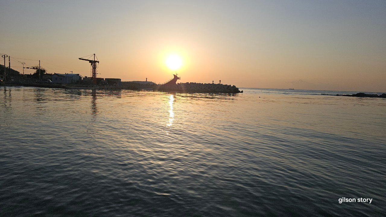 Sunrise over the breakwater and rooster-comb lighthouse at Seoam Village, Gijang, Busan