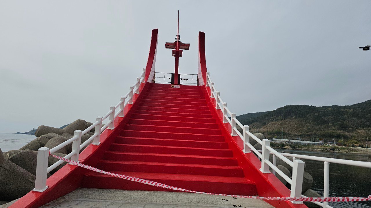 Red staircase breakwater walkway and lighthouse at Oryangdae, Gijang, Busan