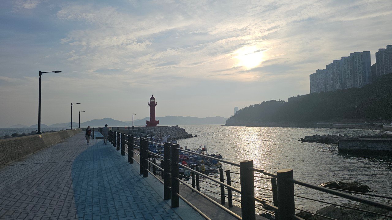 Red lighthouse at Jungni Port harbor at sunset, Yeongdo, Busan