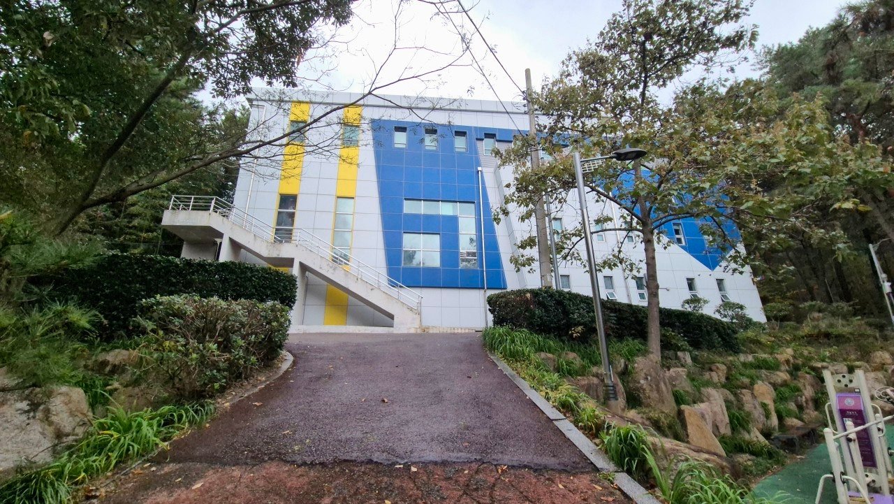 Community building surrounded by trees at Chorok Park, Haeundae, Busan